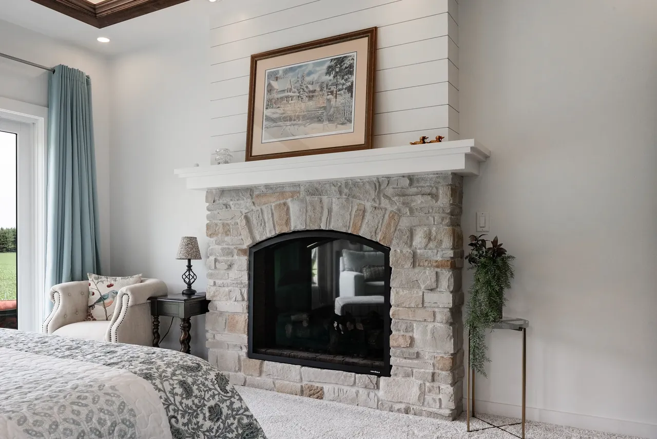 Living room with a rustic wood mantel, pale upholstery and layered textures