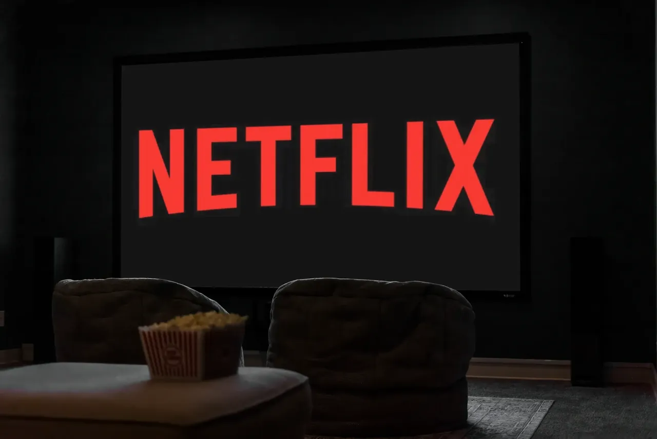 Home theater screen displaying Netflix with a popcorn bowl in the foreground